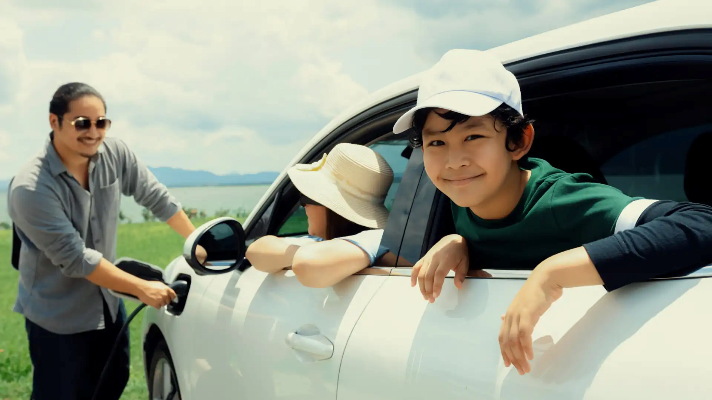 Reasons to buy an electric car – Family waiting for their EV to charge